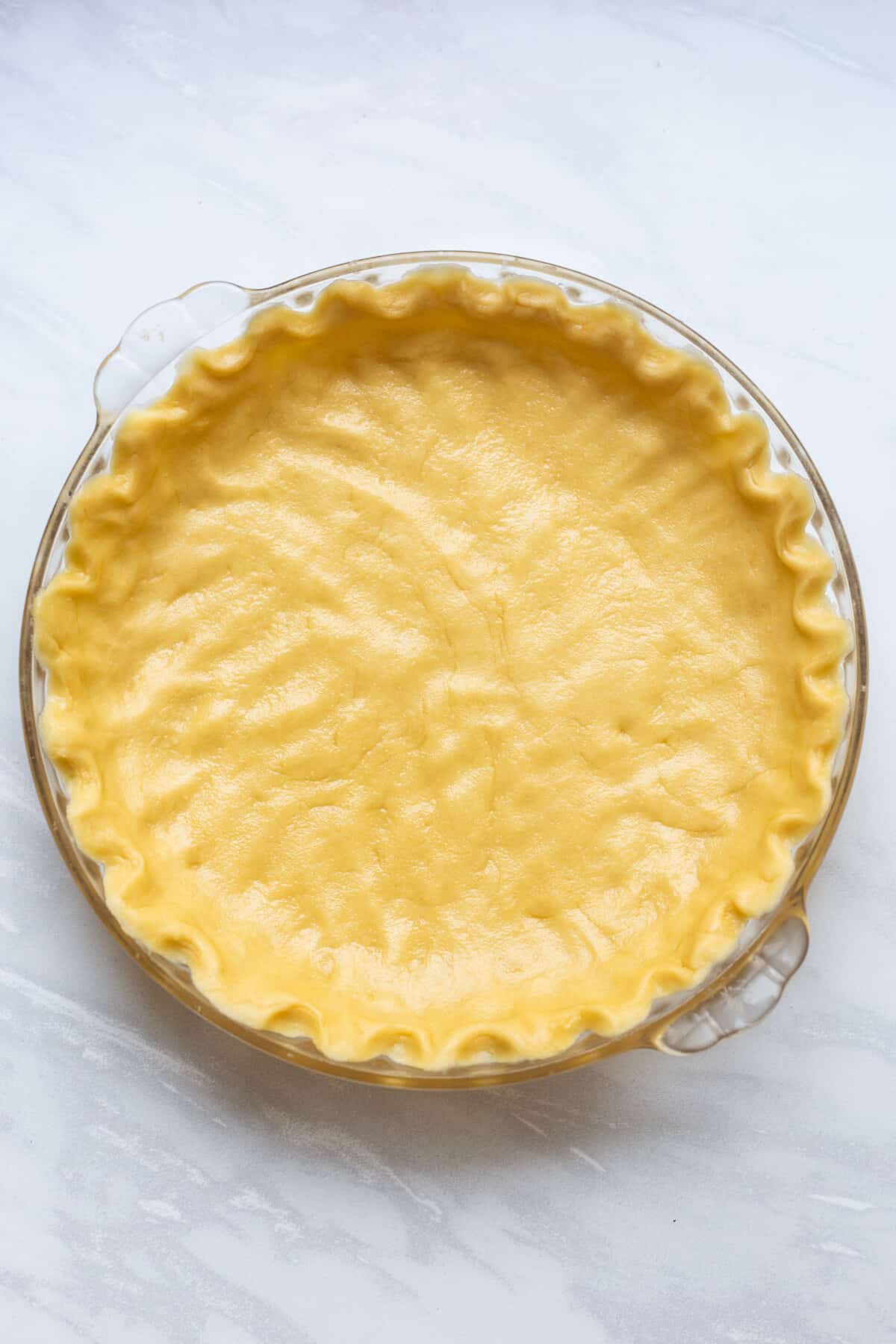 pie dish with unbaked pie crust prepared
