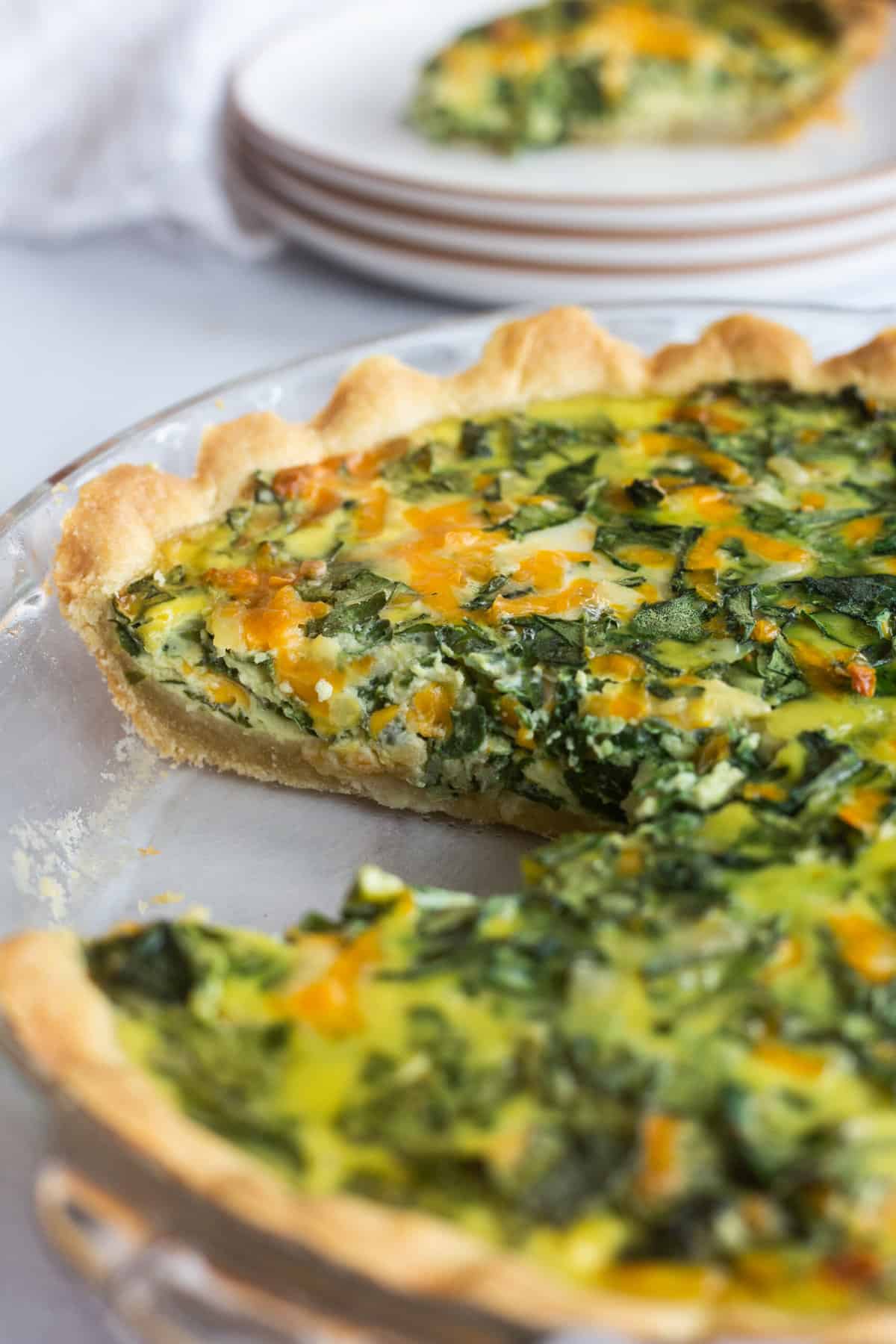 close up image of the cross section of a spinach cheese quiche