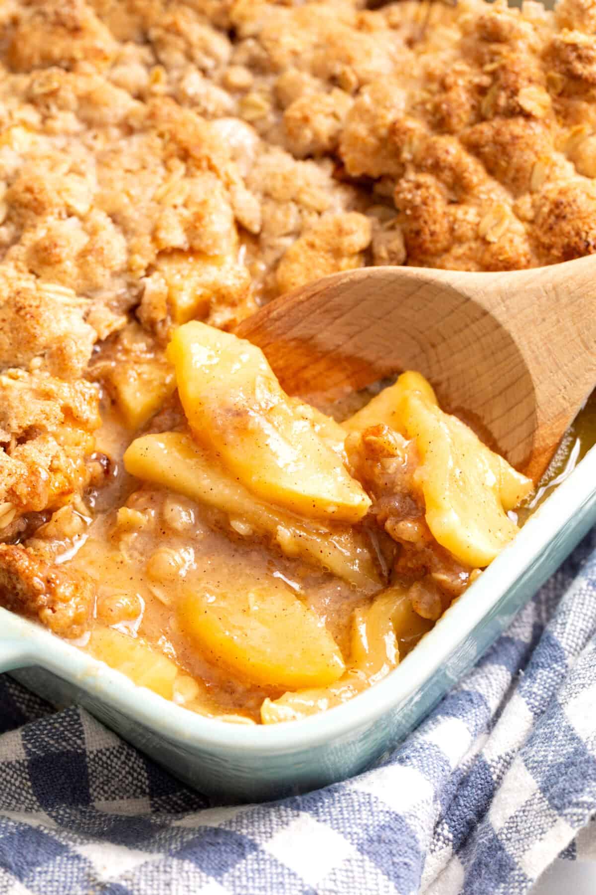 Apples sliced and layered with oat topping in a baking dish