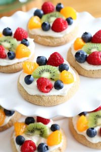 Try this semi-homemade fruit pizza on a soft sugar cookie crust and topped with a cream cheese frosting today! It's the best quick and easy Easter Dessert!