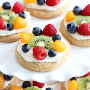 Try this semi-homemade fruit pizza on a soft sugar cookie crust and topped with a cream cheese frosting today! It's the best quick and easy Easter Dessert!