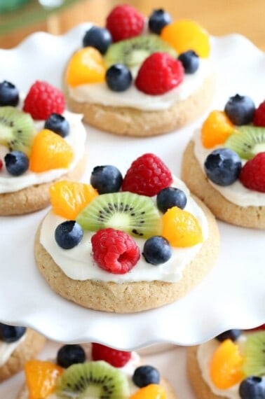 Try this semi-homemade fruit pizza on a soft sugar cookie crust and topped with a cream cheese frosting today! It's the best quick and easy Easter Dessert!