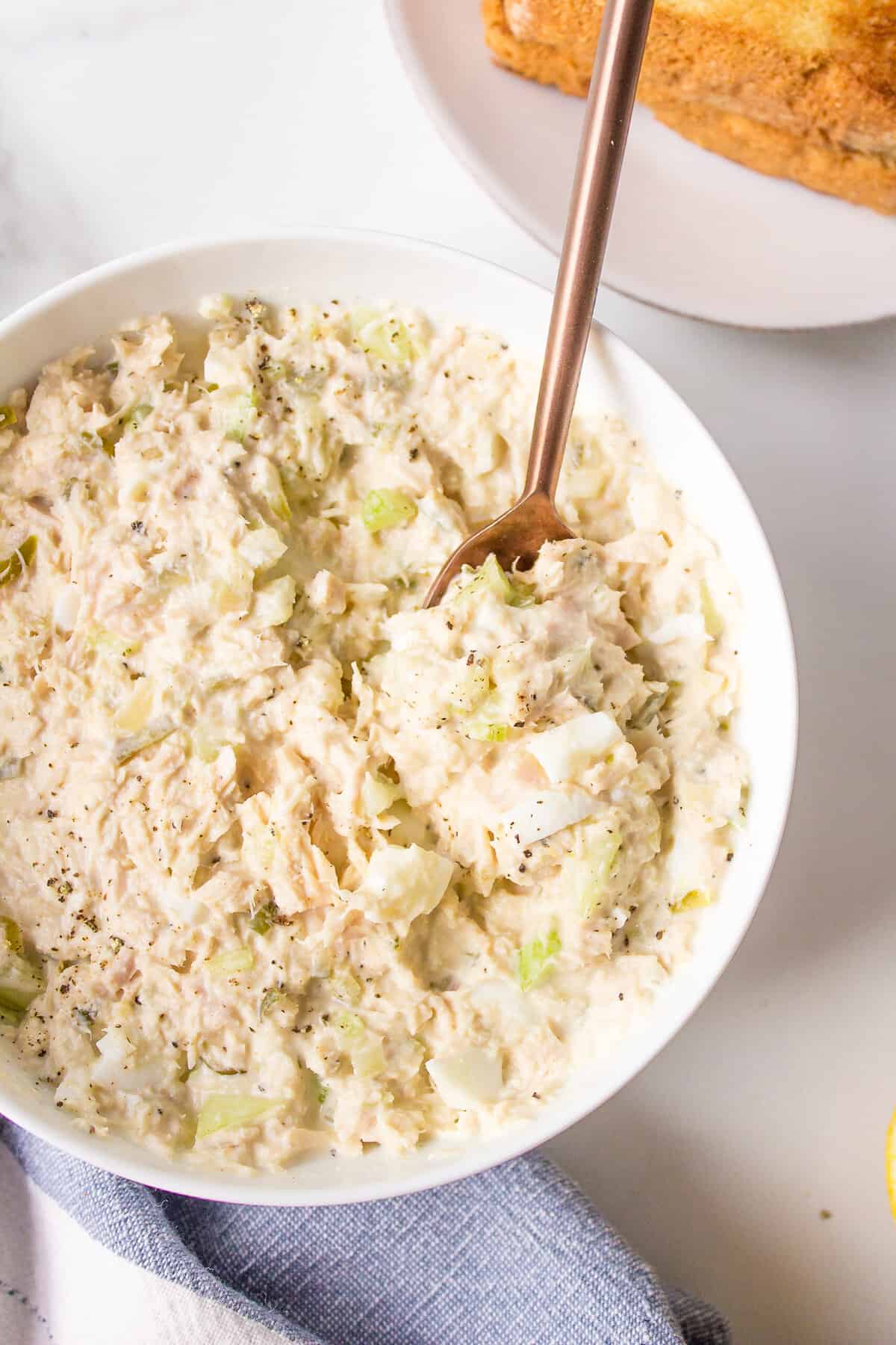top down image of tuna salad served in a white round bowl