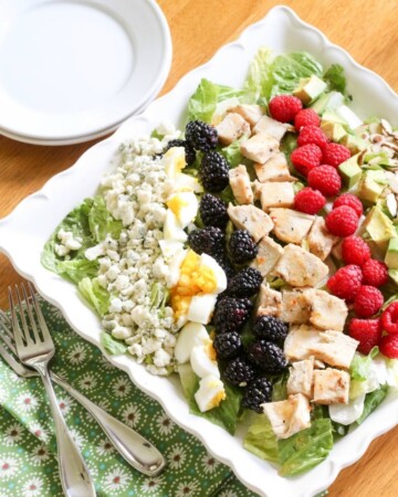 Topped with eggs, blue cheese, raspberries, blackberries, avocado, roasted almonds and chicken, this Summer Cobb Salad packs a wholesome punch!