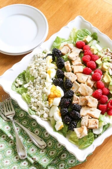 Topped with eggs, blue cheese, raspberries, blackberries, avocado, roasted almonds and chicken, this Summer Cobb Salad packs a wholesome punch!