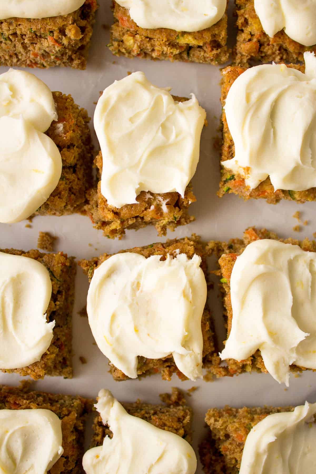 square slices of zucchini carrot bars with lemon cream cheese frosting
