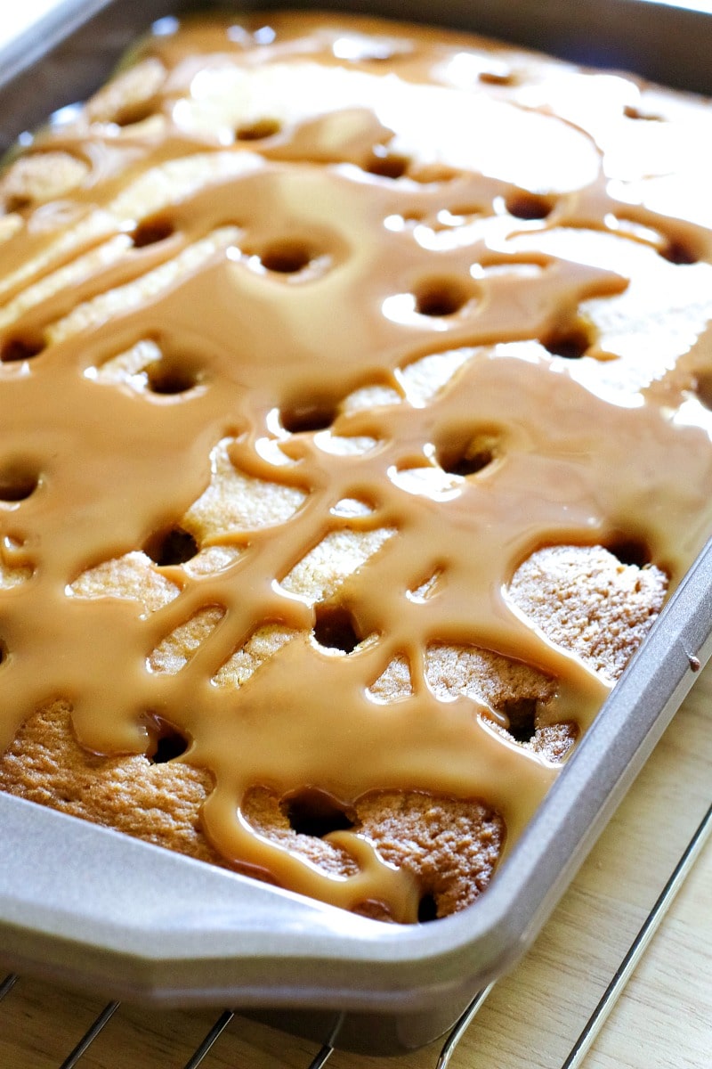 baked cake with holes filled with caramel sauce 