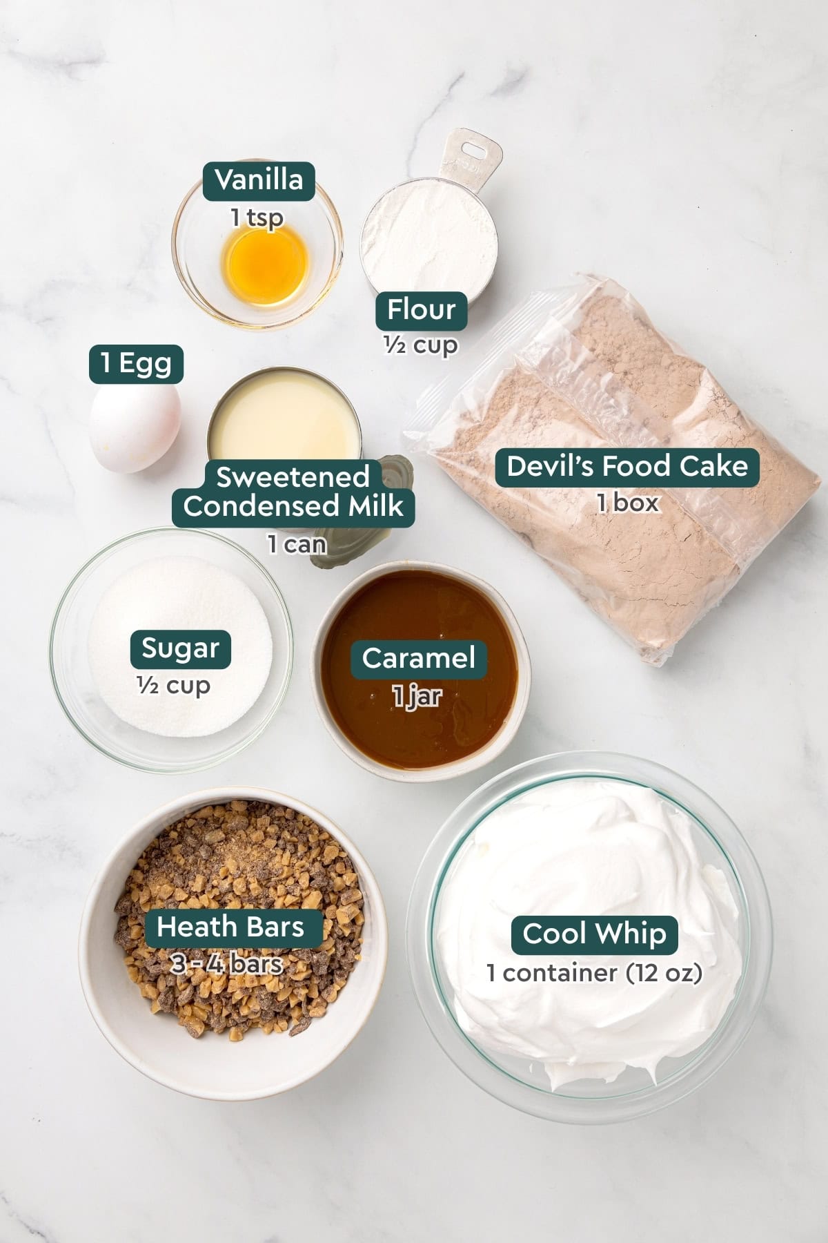 All of the ingredients for heath bar cake in bowls on a countertop.