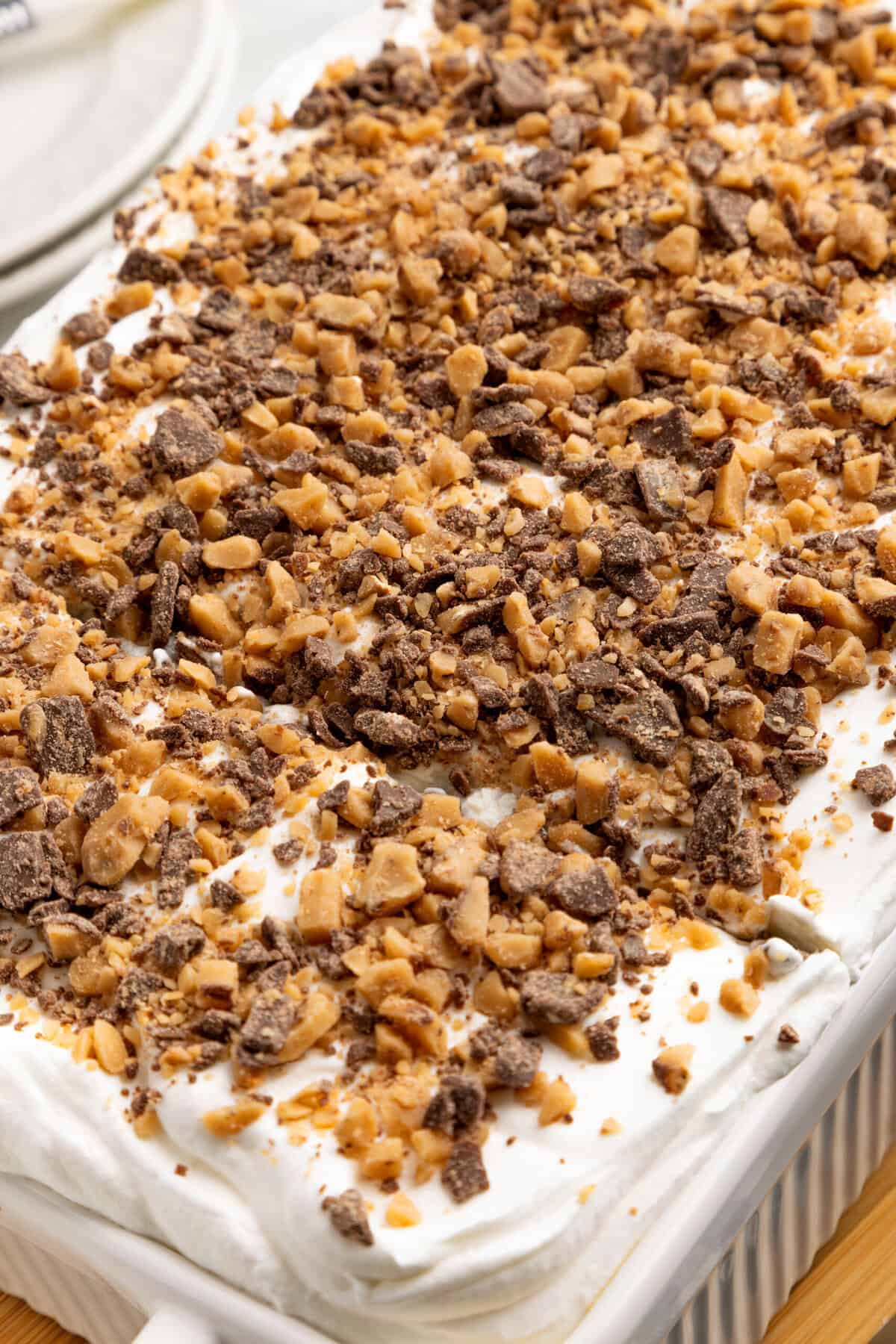 Heath Bar candy pieces on top of a Cool Whip Covered Cake.