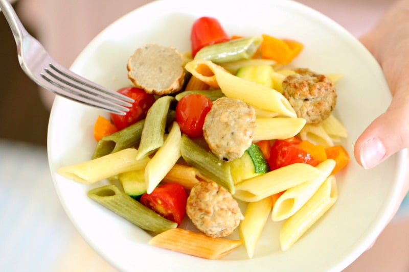 A bowl of one skillet pasta primavera with meatballs.