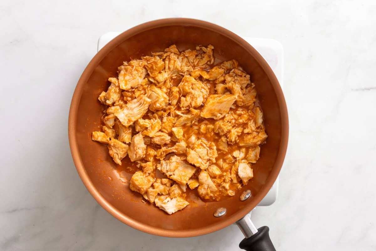 Chicken and hot sauce in skillet.
