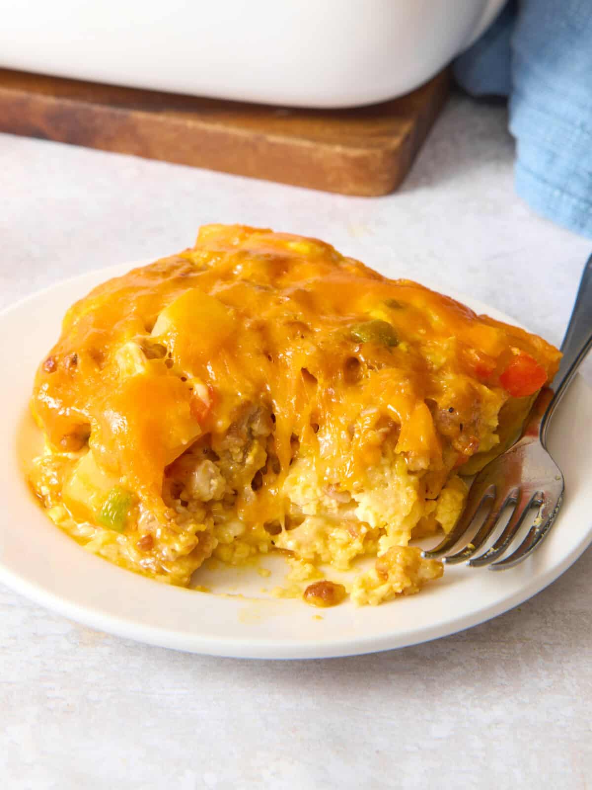 Overnight breakfast casserole on plate with fork.