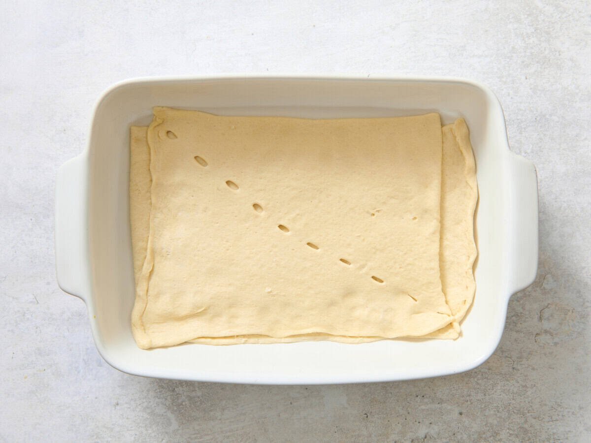 Crescent roll dough in baking dish.