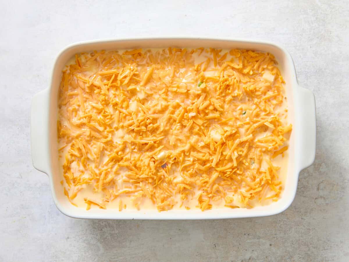 Assembled overnight egg and sausage breakfast bake before baking.