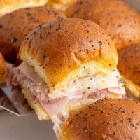 Lifting ham and Swiss slider from baking dish.