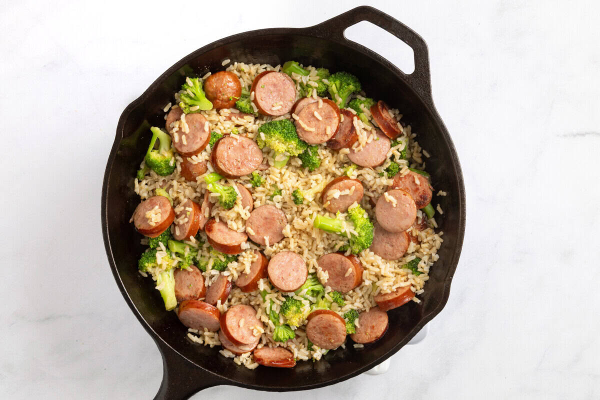 Smoked sausage, rice, and broccoli in cast iron skillet.