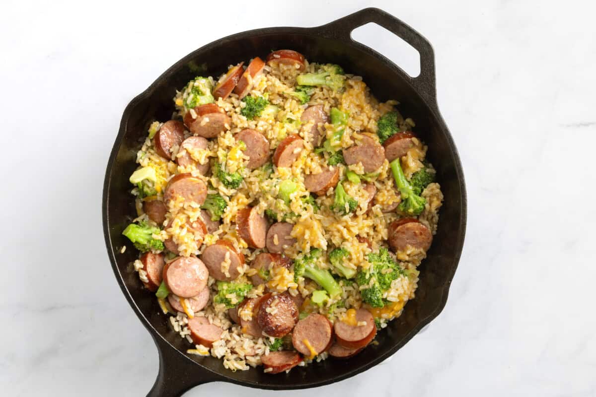 Smoked sausage and rice skillet with broccoli florets.