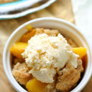 This Easy Peach Cobbler Recipe is by far one of my favorite summer desserts ever!  Made with fresh peaches, butter, and a cookie dough like topping, this will be your go-to cobbler recipe from now on! 