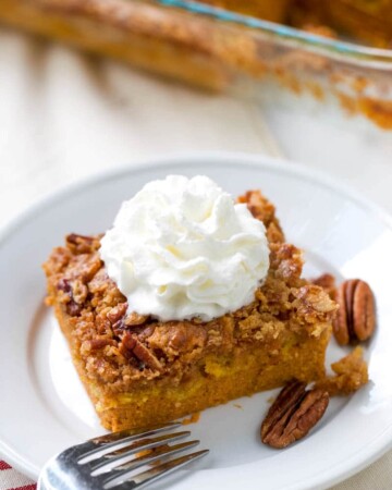 This quick and easy pumpkin dump cake is your next go-to fall dessert. Dump cakes recipes are so versatile and are perfect for serving a crowd or whipping up a quick dessert to feed your family as a treat. An easy pumpkin recipe that is a no-fail recipe. Just mix, dump, and bake. It's that easy. 