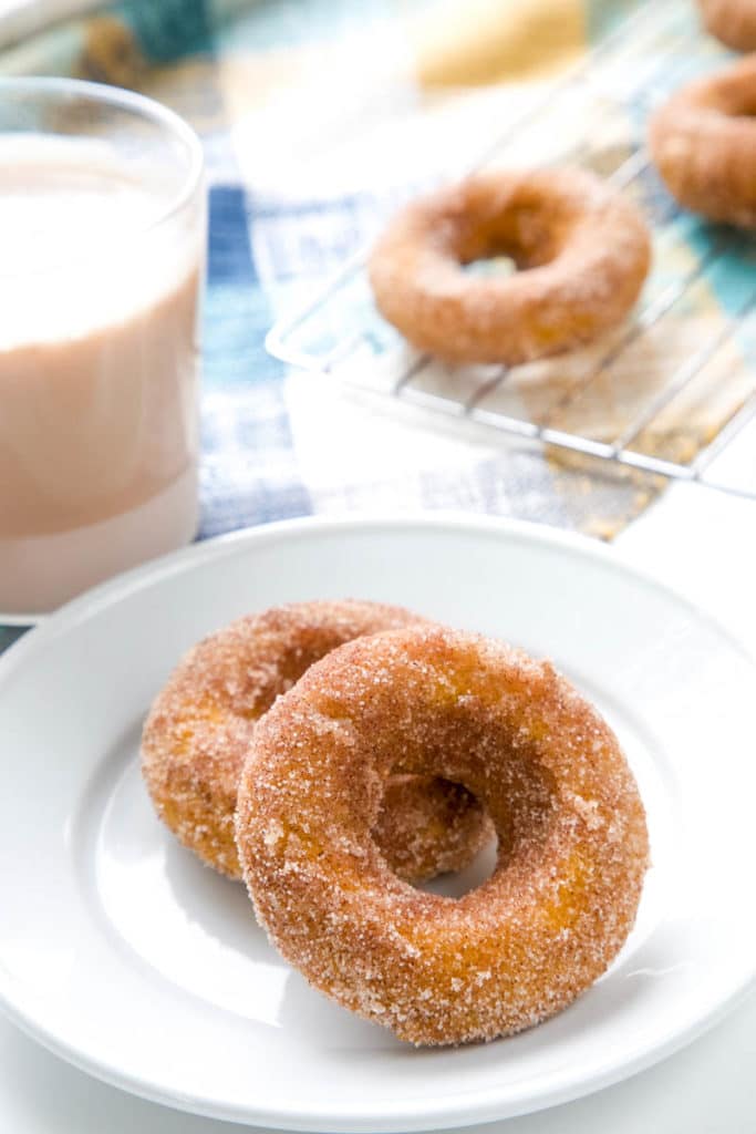  Baked Pumpkin Spice Donuts, topped with cinnamon-sugar.