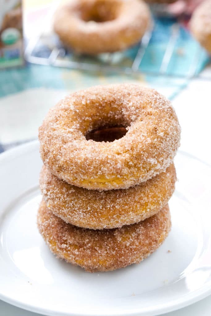 Stack of pumpkin doughnuts on a white plate 