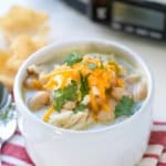 This Easy White Chicken Chili is the perfect slow cooker weeknight meal! Creamy with plenty of toppings, this soup recipe is the perfect way to end the day!