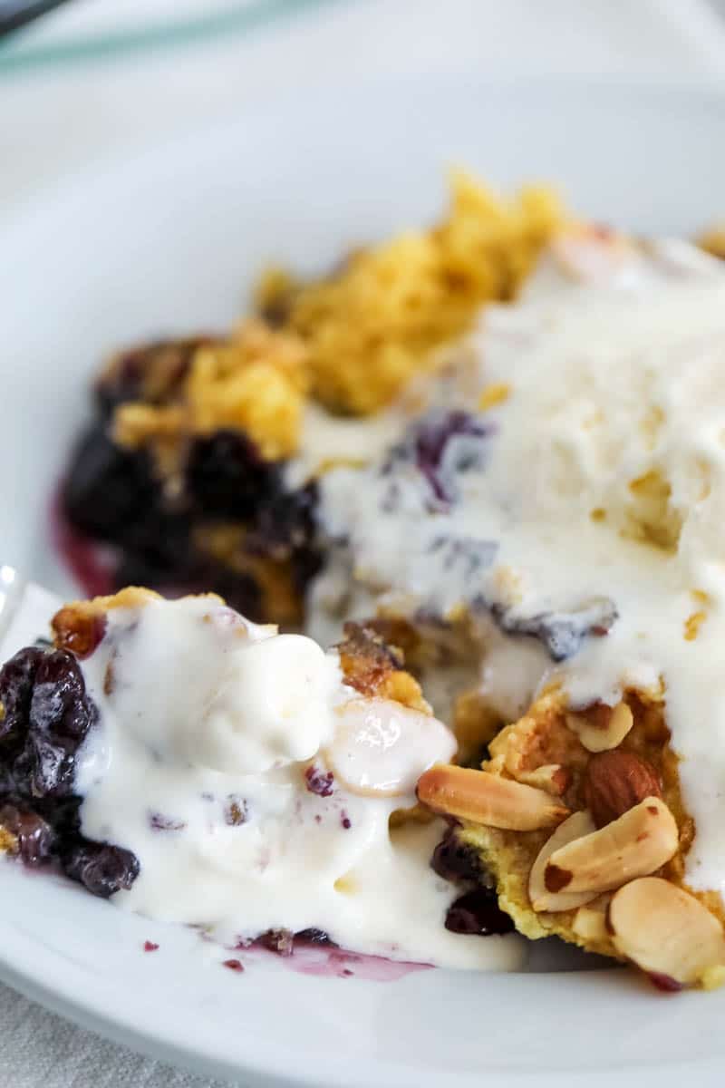 blueberry dump cake topped with ice cream 