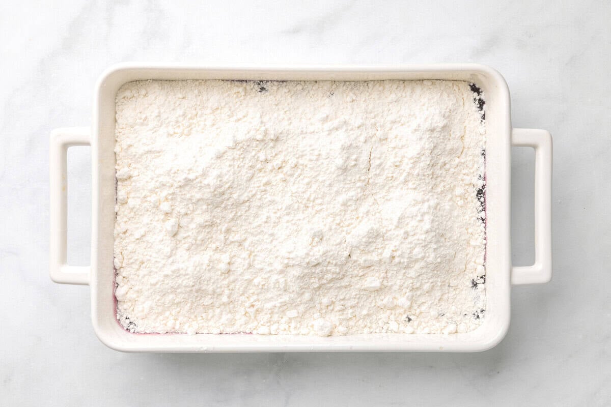 Cake mix added to baking dish.