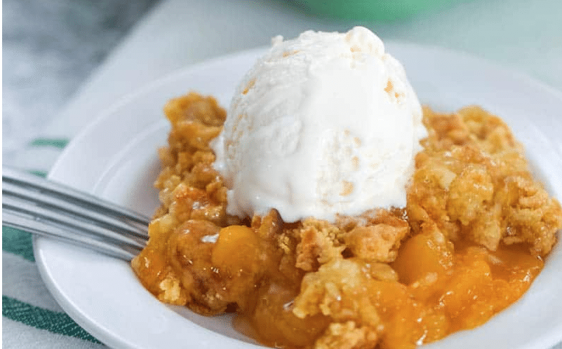 peach dump cake recipe topped with ice cream 