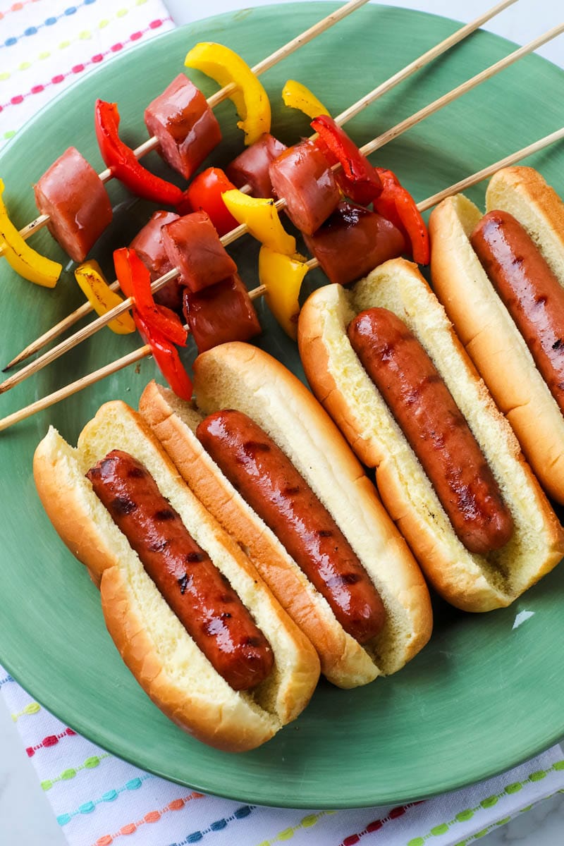 ball park hotdogs in buns on plate 