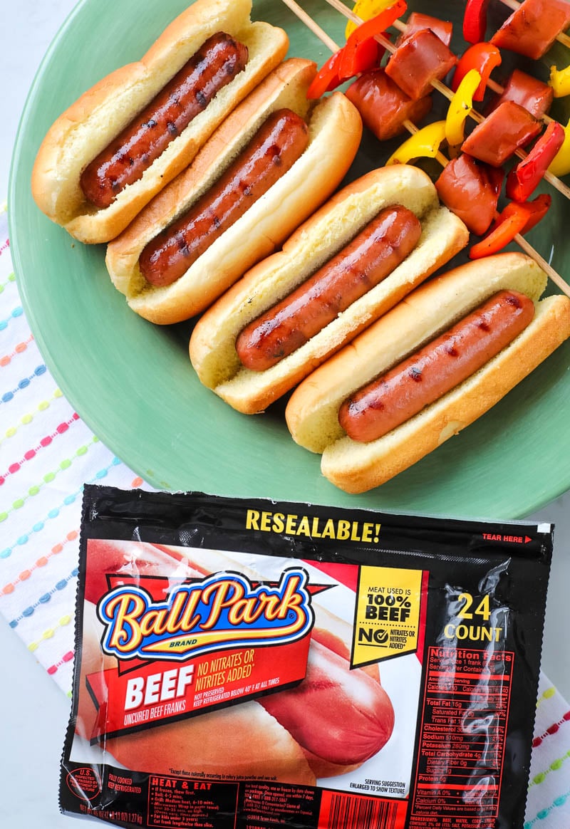 hot dogs in buns on a plate 