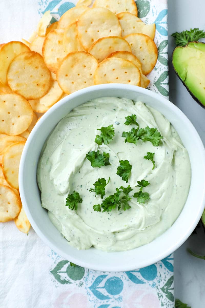 avocado dip recipe in a bowl with chips 