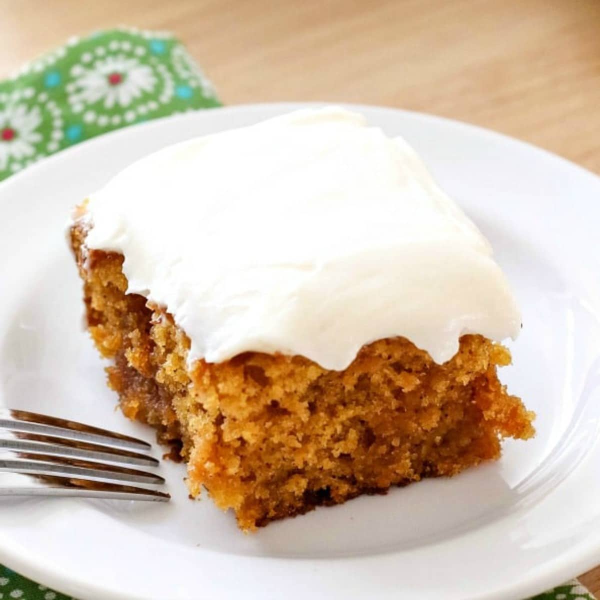 A slice of pumpkin caramel poke cake on a plate.
