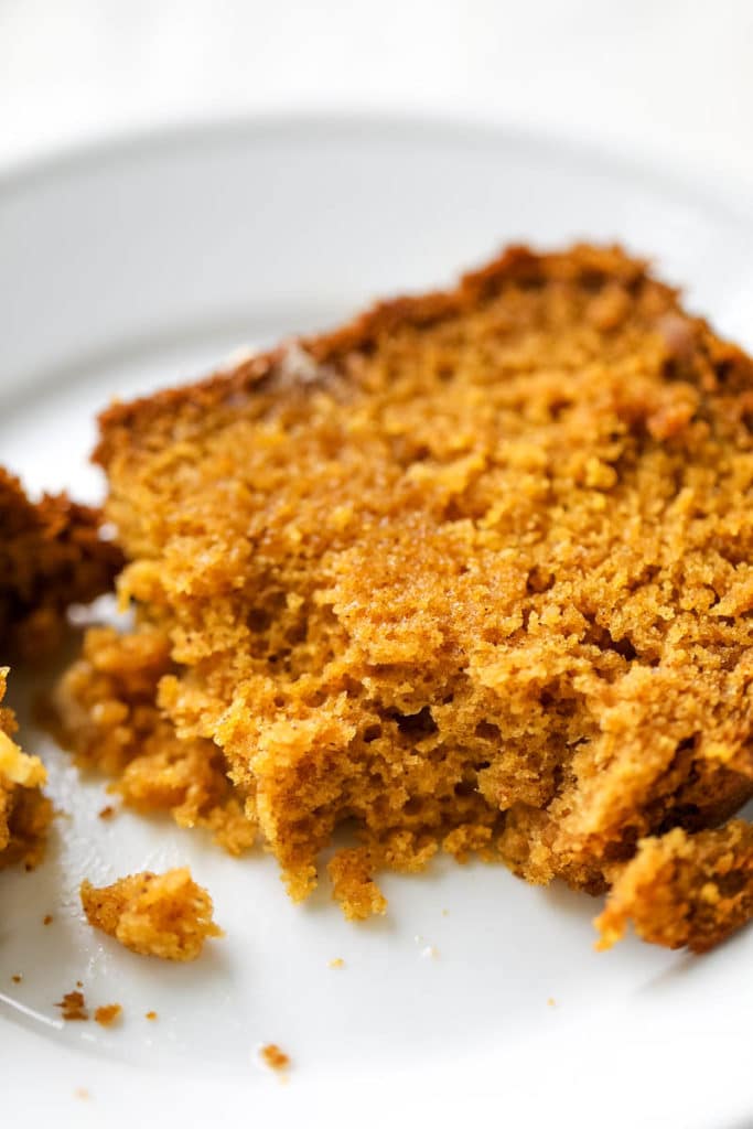 Slice of pumpkin bread half eaten and crumbling. 