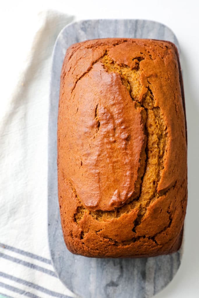 Loaf of baked pumpkin bread from a top down view. 