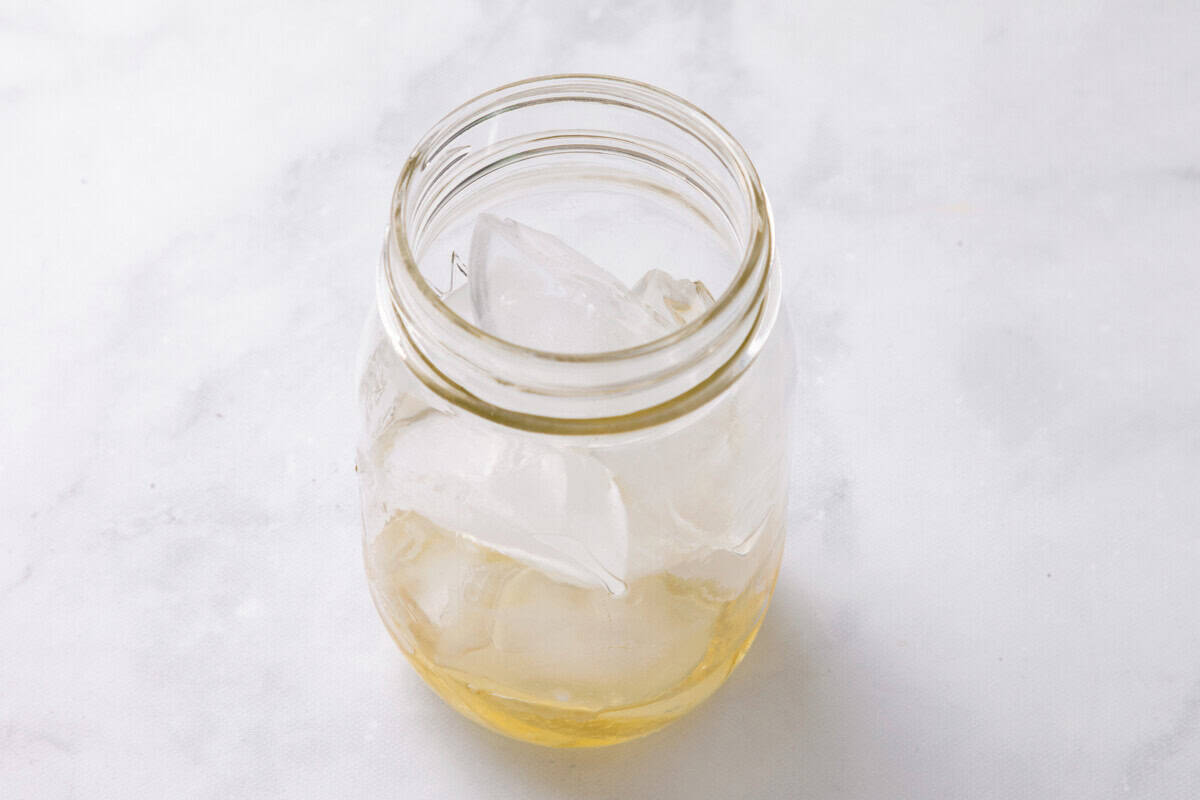 Ice and syrup in mason jar.
