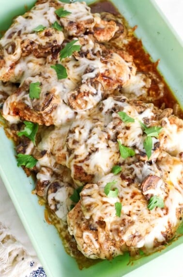 Baked chicken with mushrooms and cheese in a baking dish.