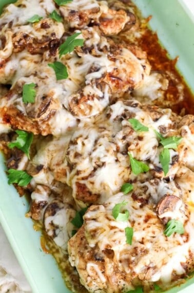 Baked chicken with mushrooms and cheese in a baking dish.