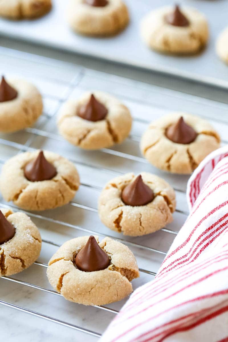 peanut butter kiss cookies on a table with a towel.