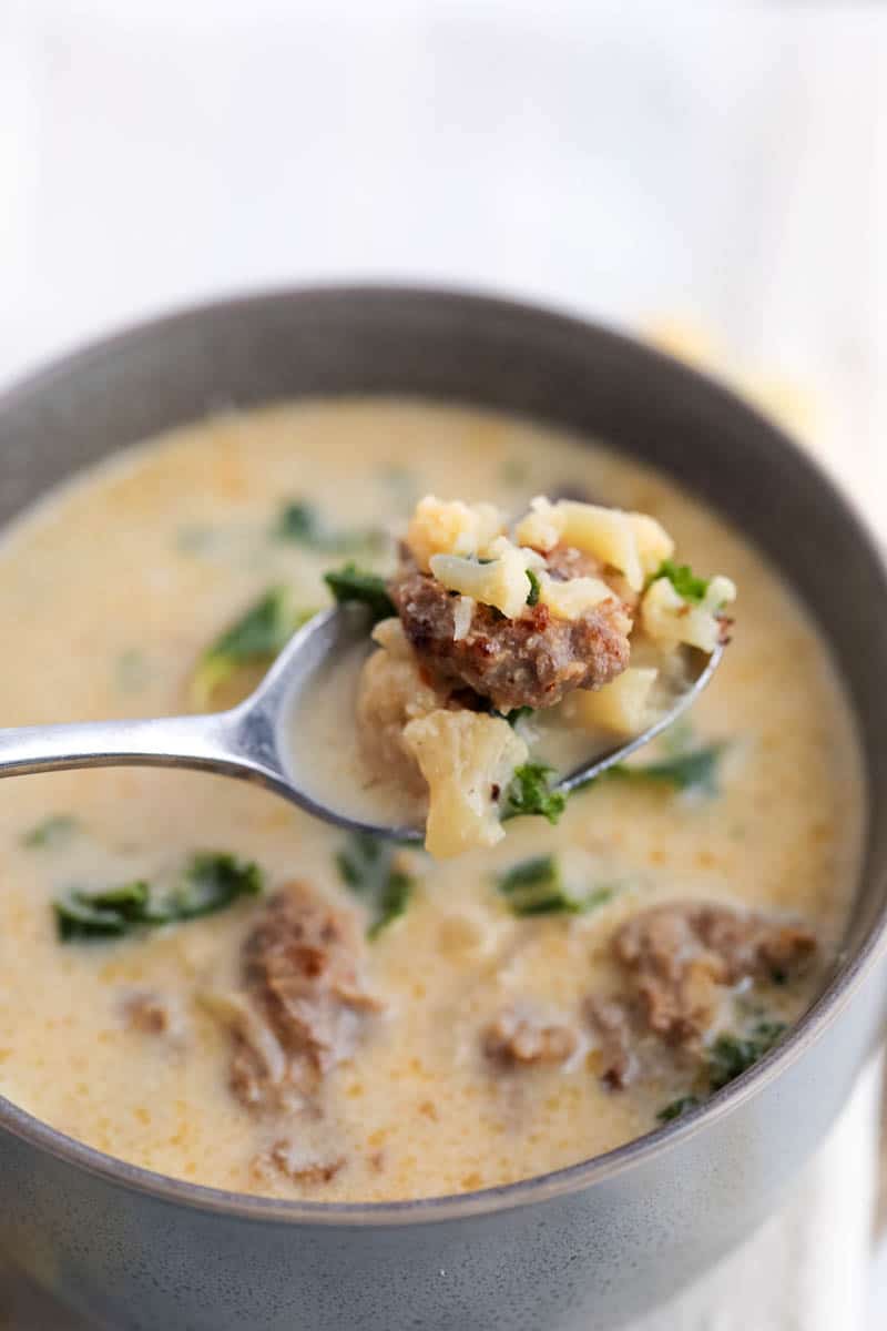 close up of keto zuppa toscana soup on a spoon 