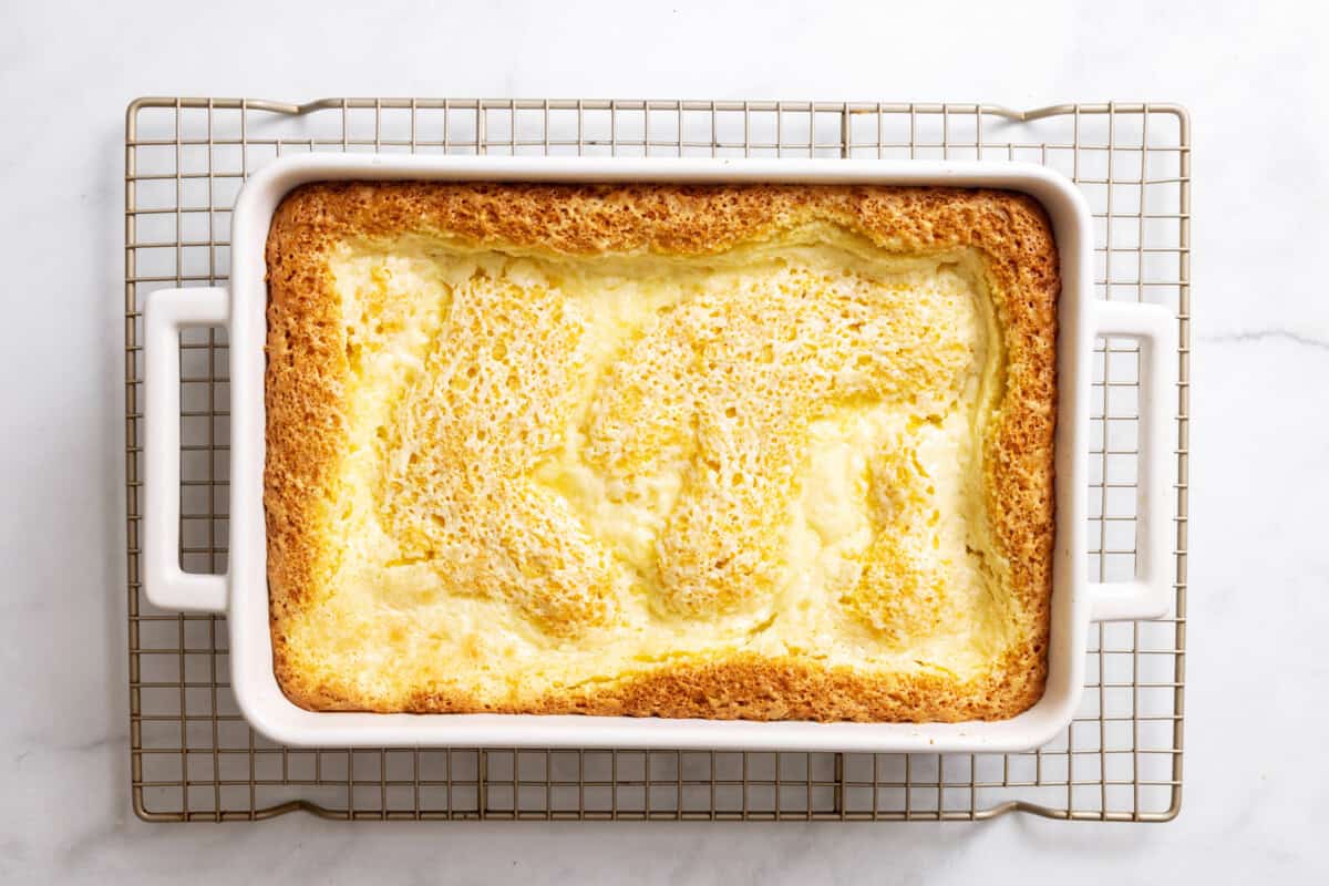 Ooey gooey butter cake in pan on wire rack.