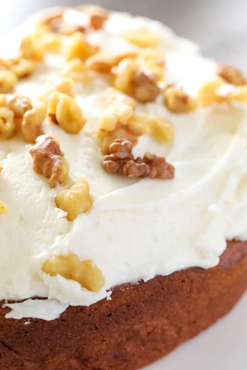 banana cake topped with frosting and nuts 