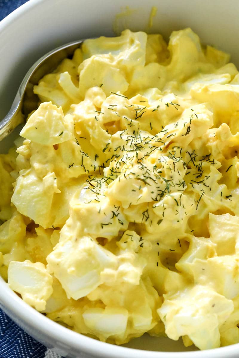 egg salad in a white bowl with a spoon