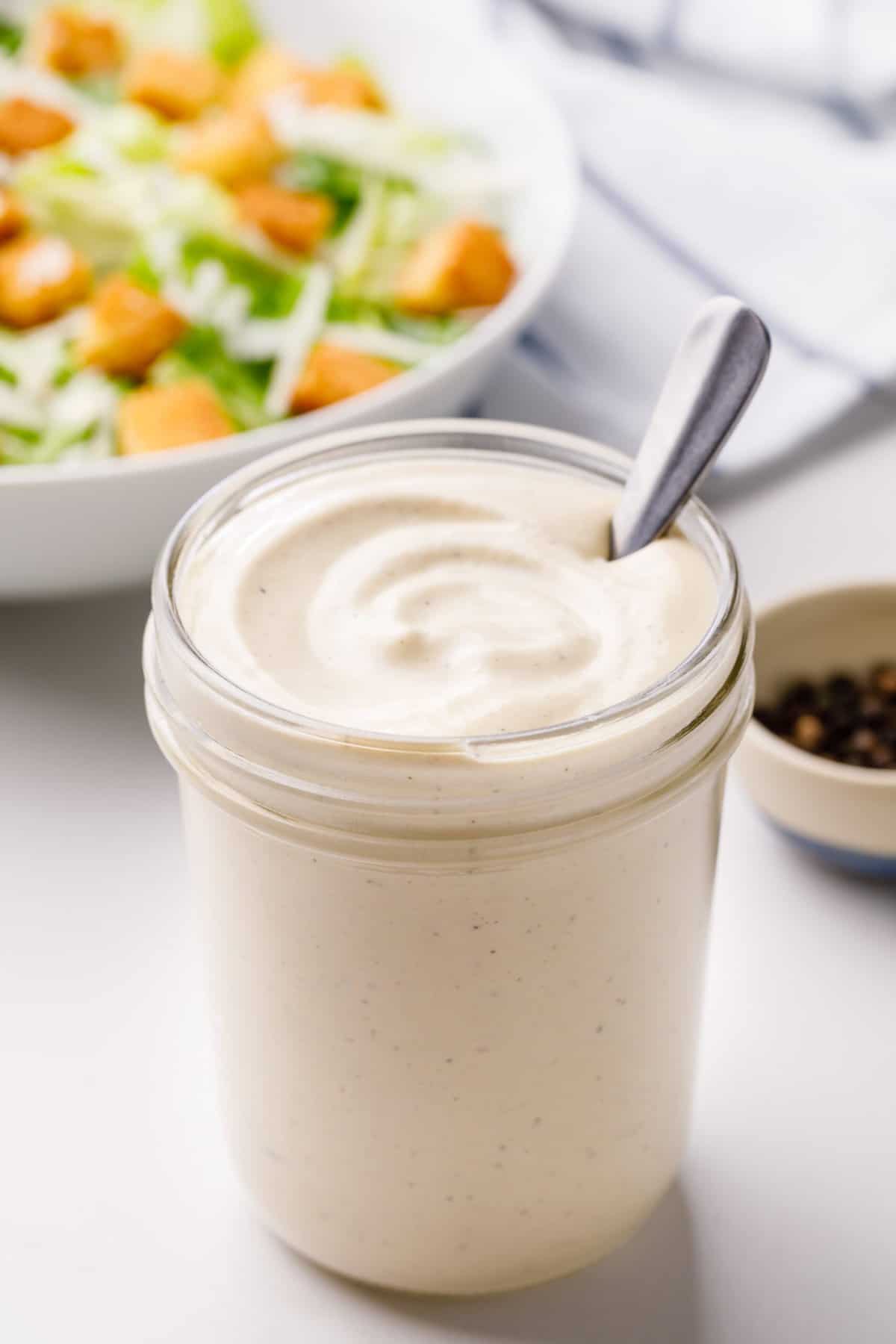 homemade caesar dressing stored in a mason jar