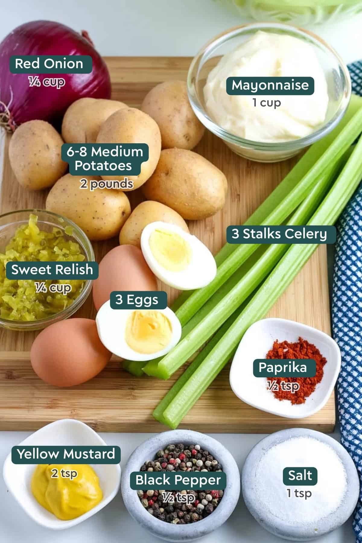 Ingredients for creamy potato salad, including mayo, onion, potatoes, hard-boiled eggs, celery, relish, mustard, and seasonings.