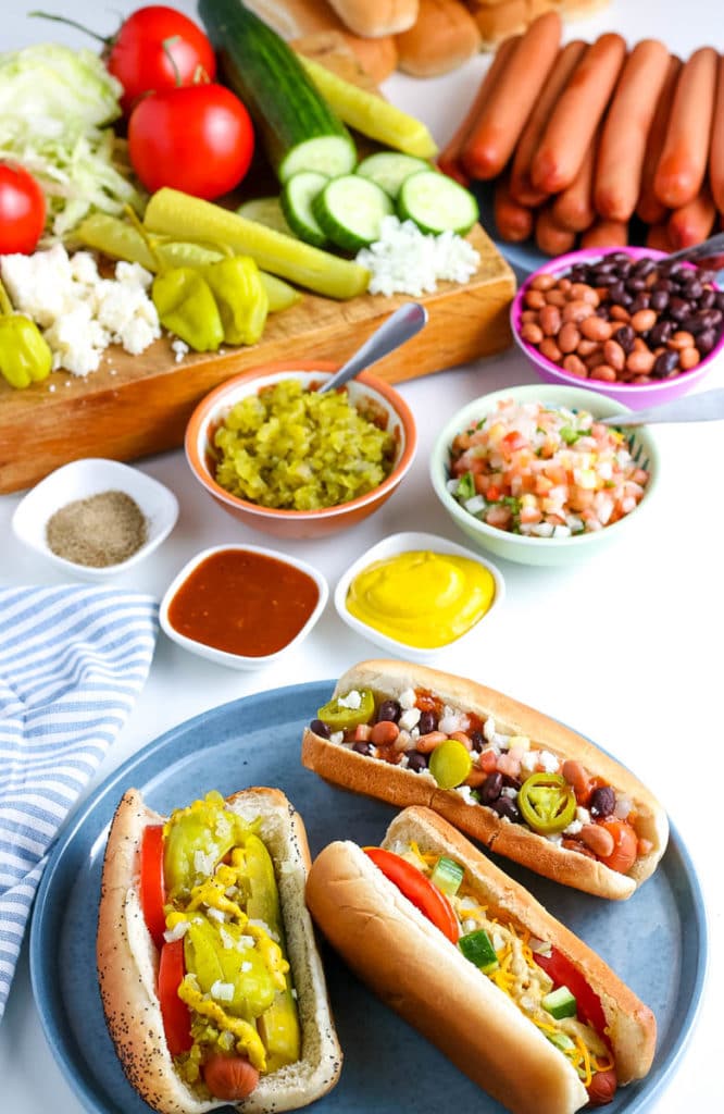 hot dogs with toppings on a plate 