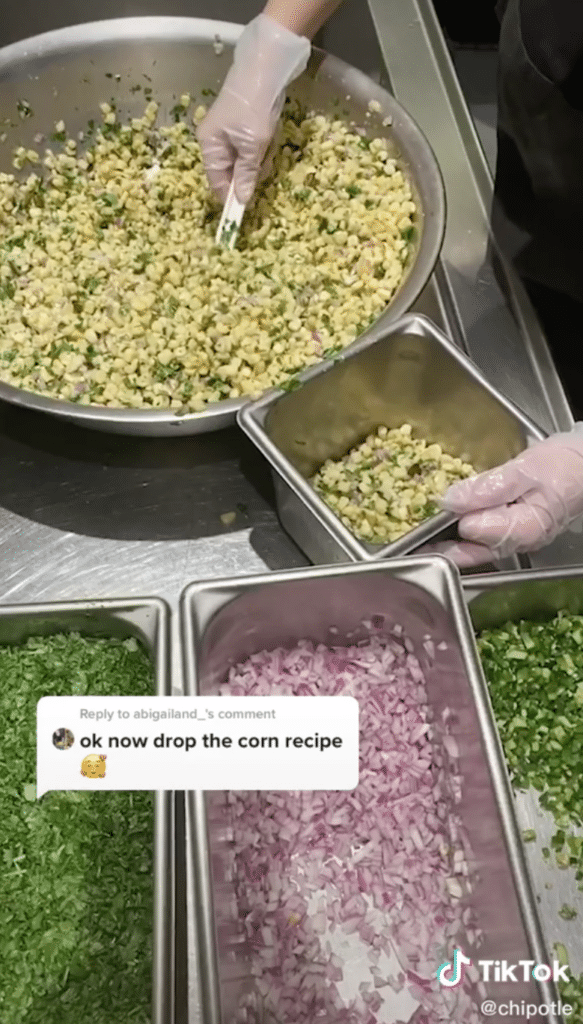 scooping the corn salsa into a container 