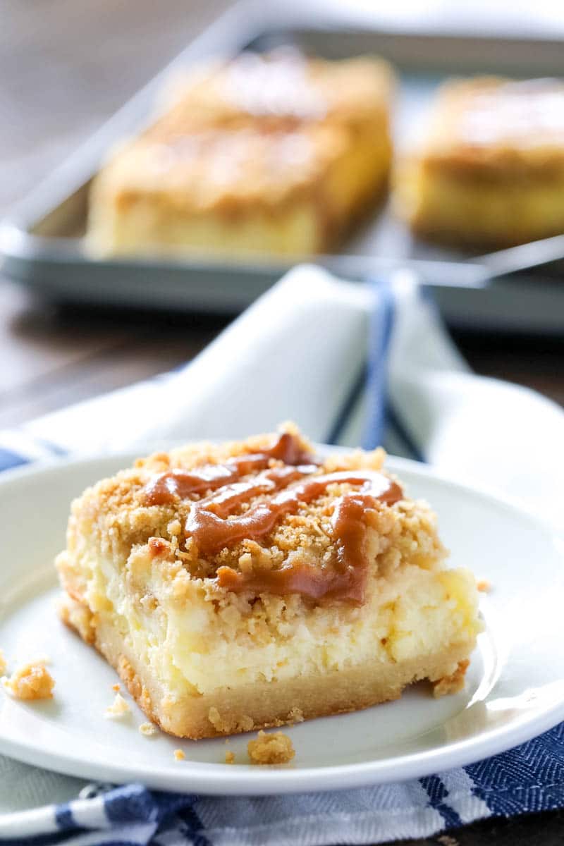 Caramel Apple Cheesecake Bars on a white plate. 