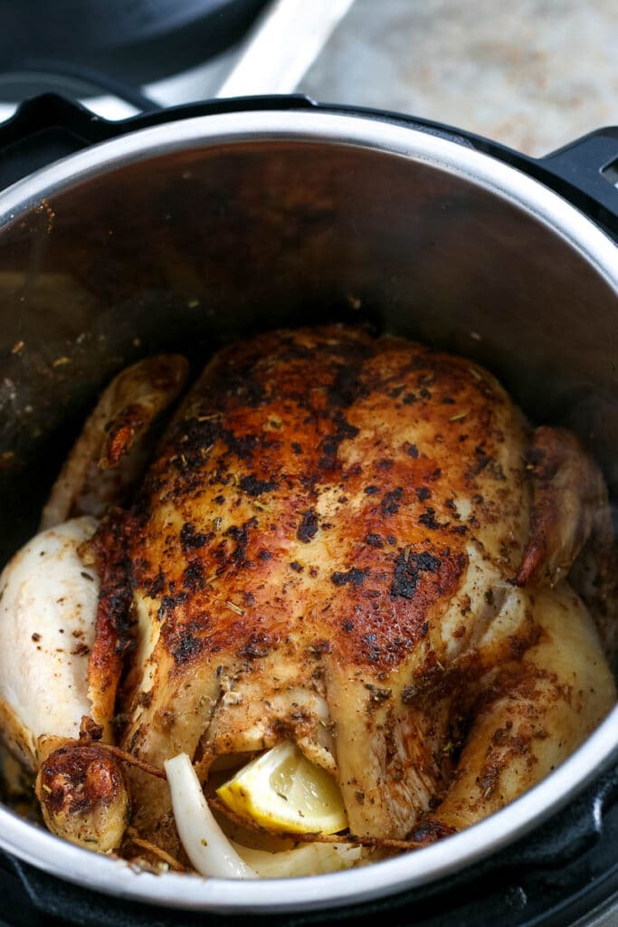 adding whole chicken to instant pot to cook