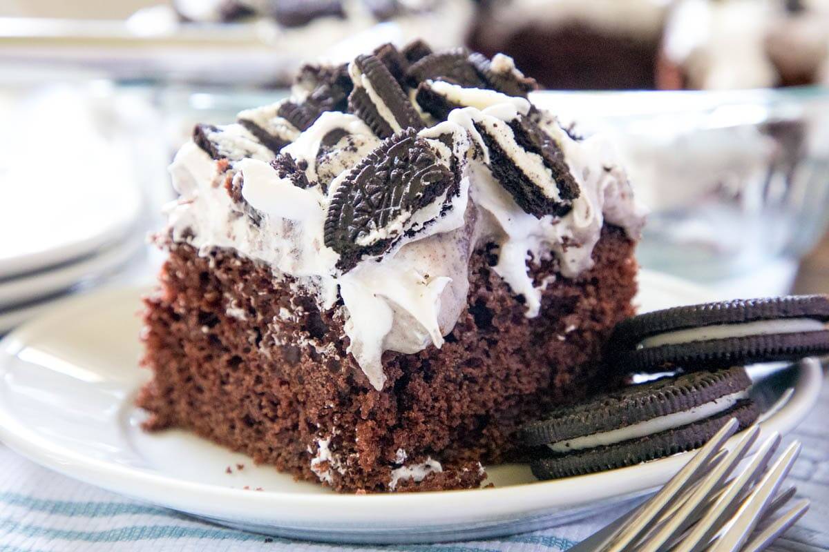 A slice of Oreo poke cake on a plate.